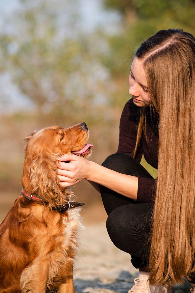 young girl hugging her puppy